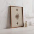 Minimal neutral nursery wall art with soft brown starburst design