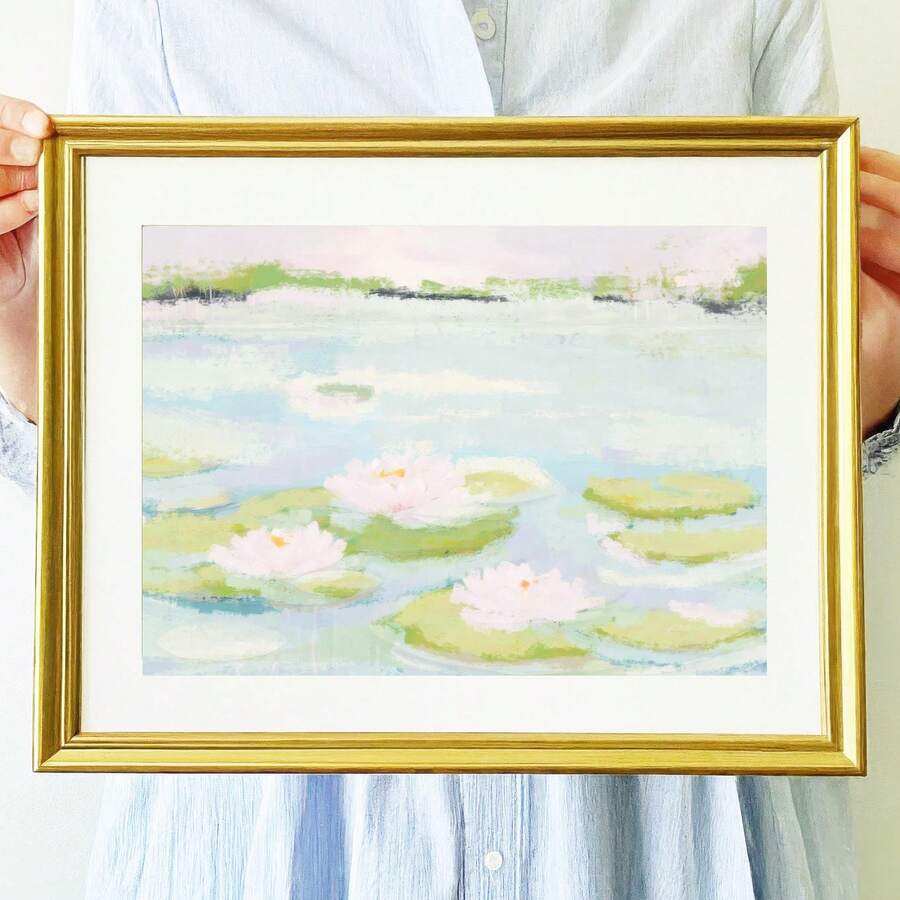 room mockup view of Framed pastel wall art print showing an abstract lily pond with water lilies, lily pads, pale blue, mint green, blush pink and gold frame styling.