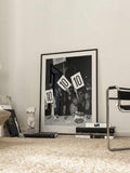 Black and white party photography canvas poster in a white matted frame on a gallery wall