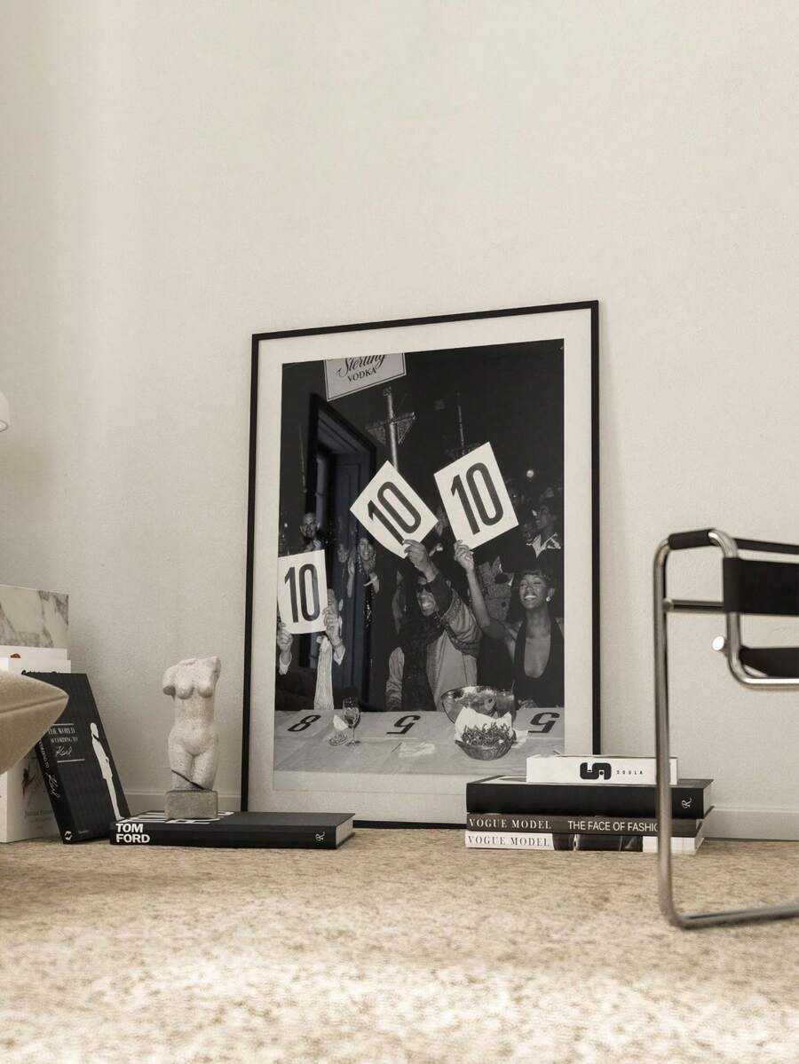 Black and white party photography canvas poster in a white matted frame on a gallery wall