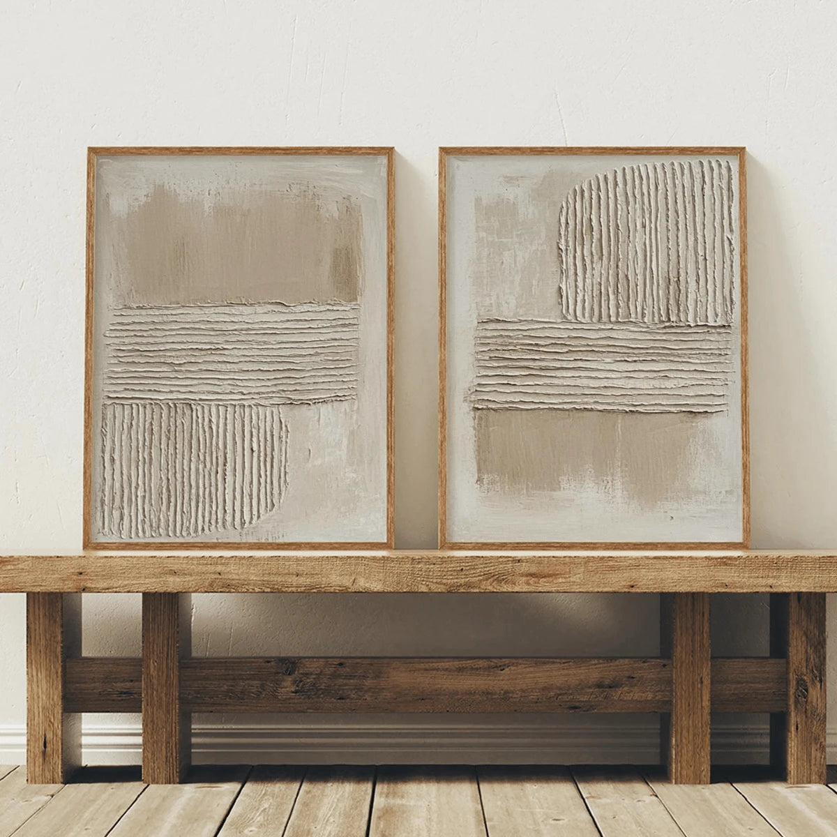 Matching beige abstract canvases displayed together in slim wood frames