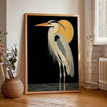 Framed heron wall art leaning on floor in sunlit room with plant and radiator