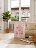 Pink striped kindness poster displayed in a living room