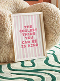 Pink kindness quote wall art in a gold frame above a turntable