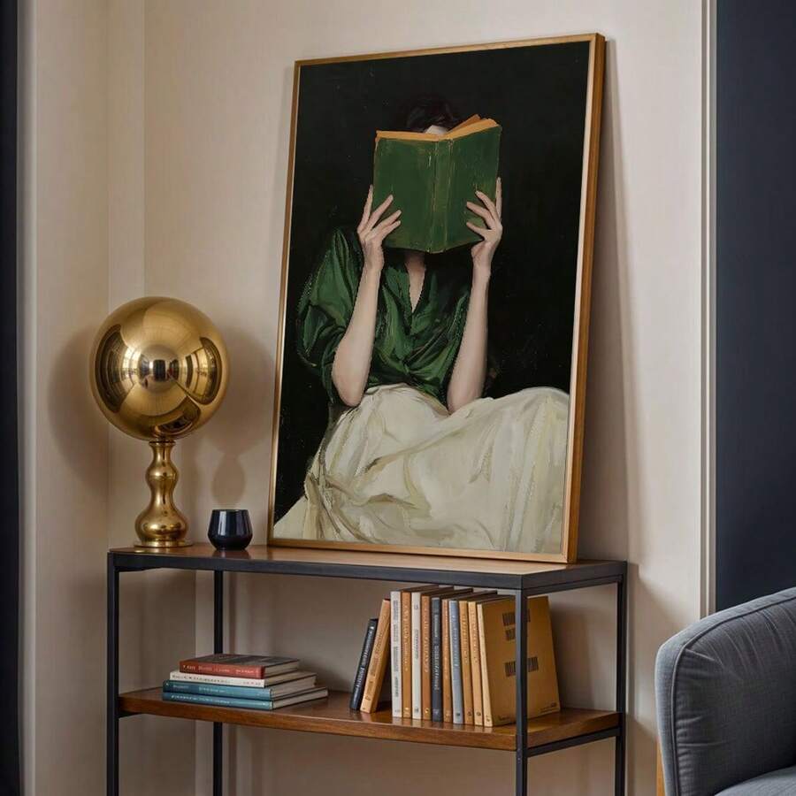 Gold framed reading woman poster on console