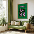 Large cat wall art above green sofa in bright living room