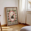 frame option view of Whimsical woodland canvas wall art showing a cute skunk holding a red flower with golden star, floral vines and vintage harlequin pattern.