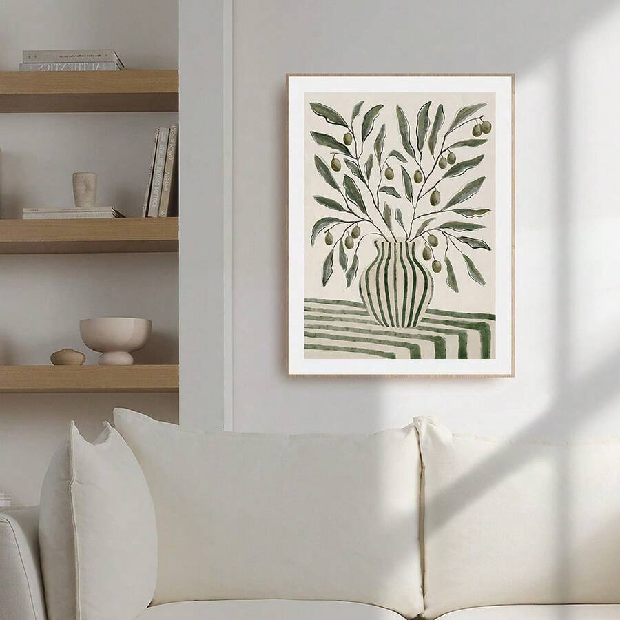 Green olive vase botanical framed wall art above cream sofa in neutral living room