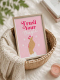 Pink Trust Your Magic poster styled with a woven bedside basket