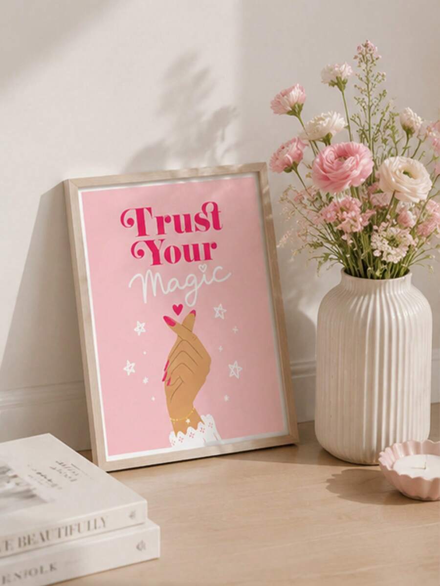 Framed Trust Your Magic affirmation artwork beside pink flowers