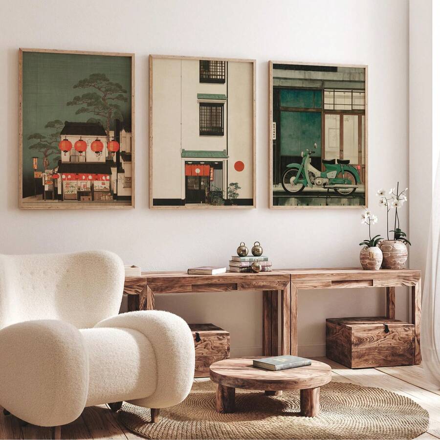 Japanese architectural triptych above a rustic wood console and cream chair