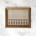 Antique floral fabric wall art in ornate gold frame