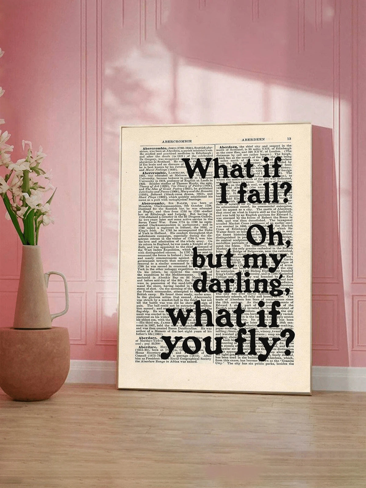 Framed faith quote canvas staged against a pink wall with flowers