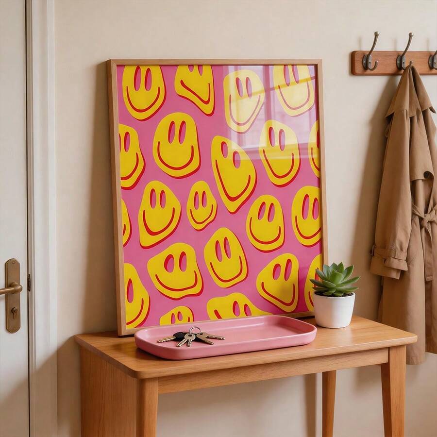 Pink smiley face poster in wood frame on console