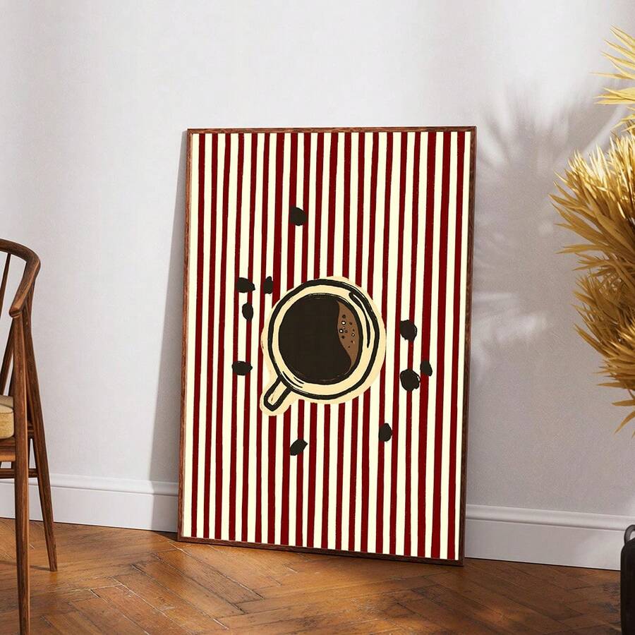 Framed coffee cup and beans print with red stripes near wood cabinet