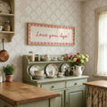 Pink cursive wall art styled on kitchen counter
