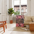 Framed pink flower and leopard collage beside beige sofa and window