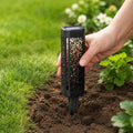 Garden stake lights installed along lawn border with warm decorative ground pattern