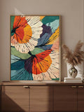 Colorful layered abstract flowers displayed above a wooden sideboard