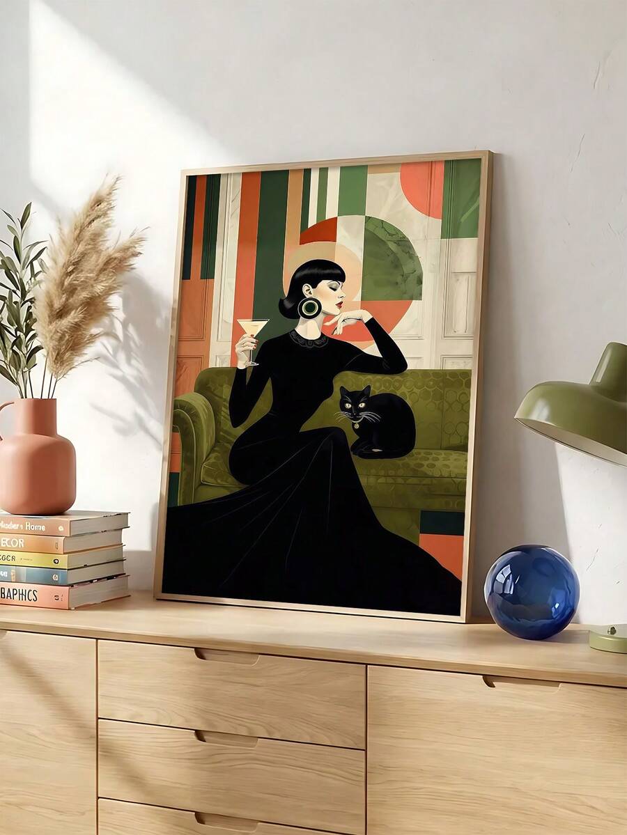 Woman with a cocktail beside a black cat and green sofa in a wood-framed portrait print above a dresser