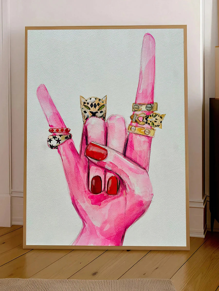 Pink rock hand wall art with red nails and gold rings