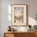 Natural wood framed mosque courtyard canvas above a sunlit credenza with pottery and plants