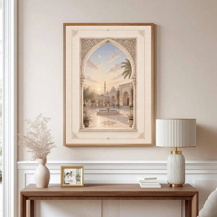 Wood framed pale courtyard wall art above a console with an ornate arch fountain and crescent sky