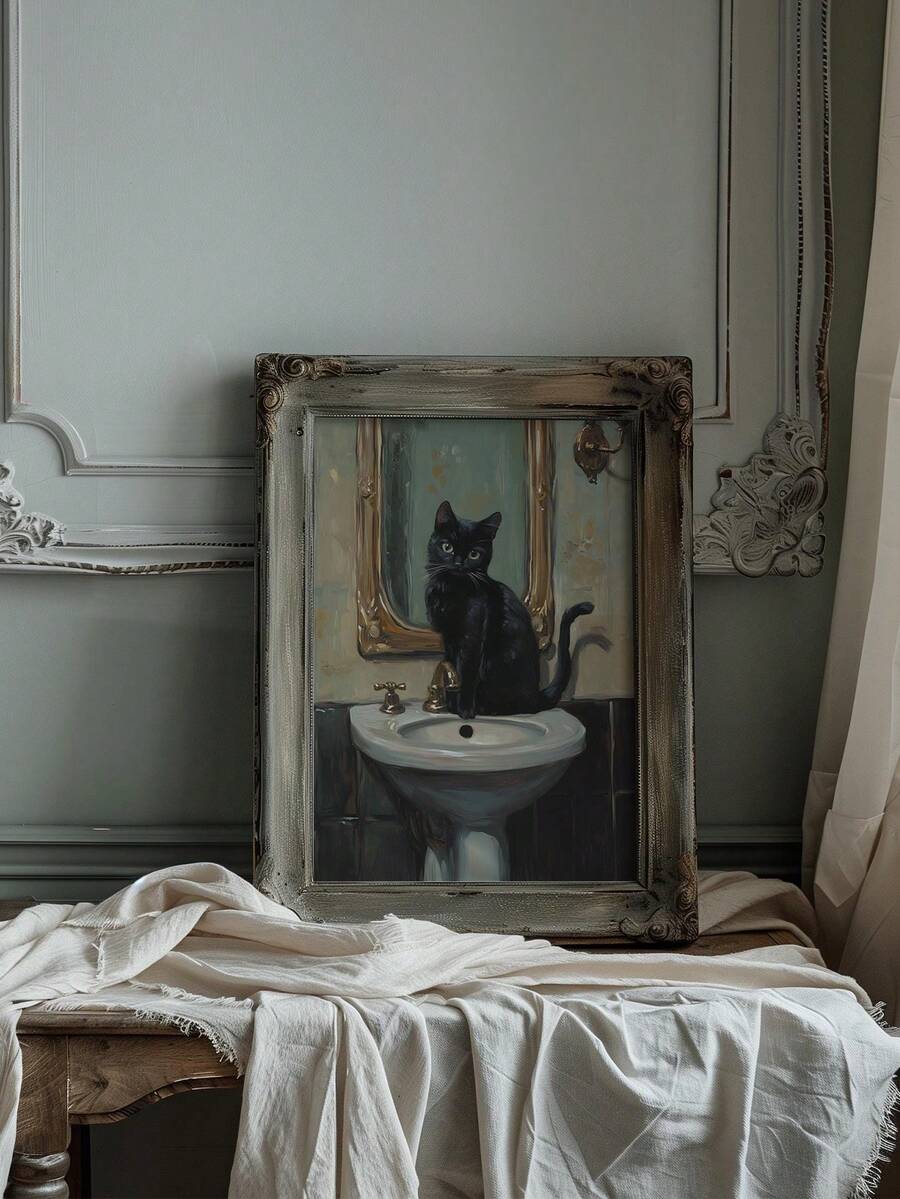 Vintage framed cat artwork with gold mirror and white sink