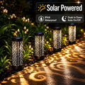 Solar path lights warm patterned glow along outdoor walkway with scroll cutout projection