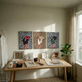 Three zebra-print Western fashion prints above a wood worktable in a sunlit studio