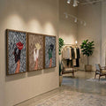 Zebra fashion triptych with red, tan, and green cowboy boot designs in a boutique interior