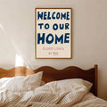 Blue and pink typography wall art in a light wood frame over a headboard