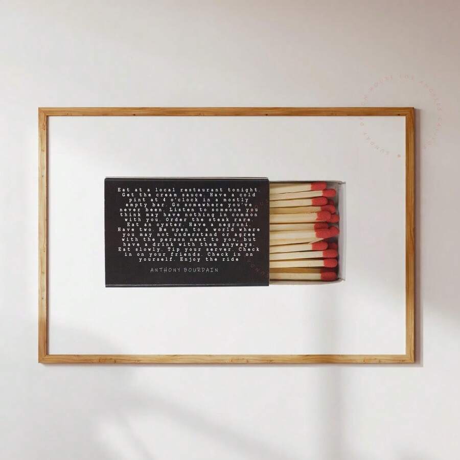 Anthony Bourdain quote poster with matchbox and red matches in wood frame