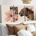 Leopard wall art three panel set above bed with pink hibiscus flowers and blush tones