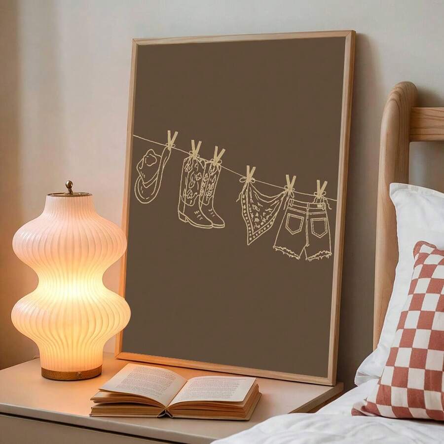 Neutral framed western clothesline print showing hat cowboy boots bandana and denim shorts with clothespins