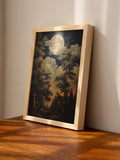 Light wood framed moonlit forest landscape poster on wooden table in warm sunlight