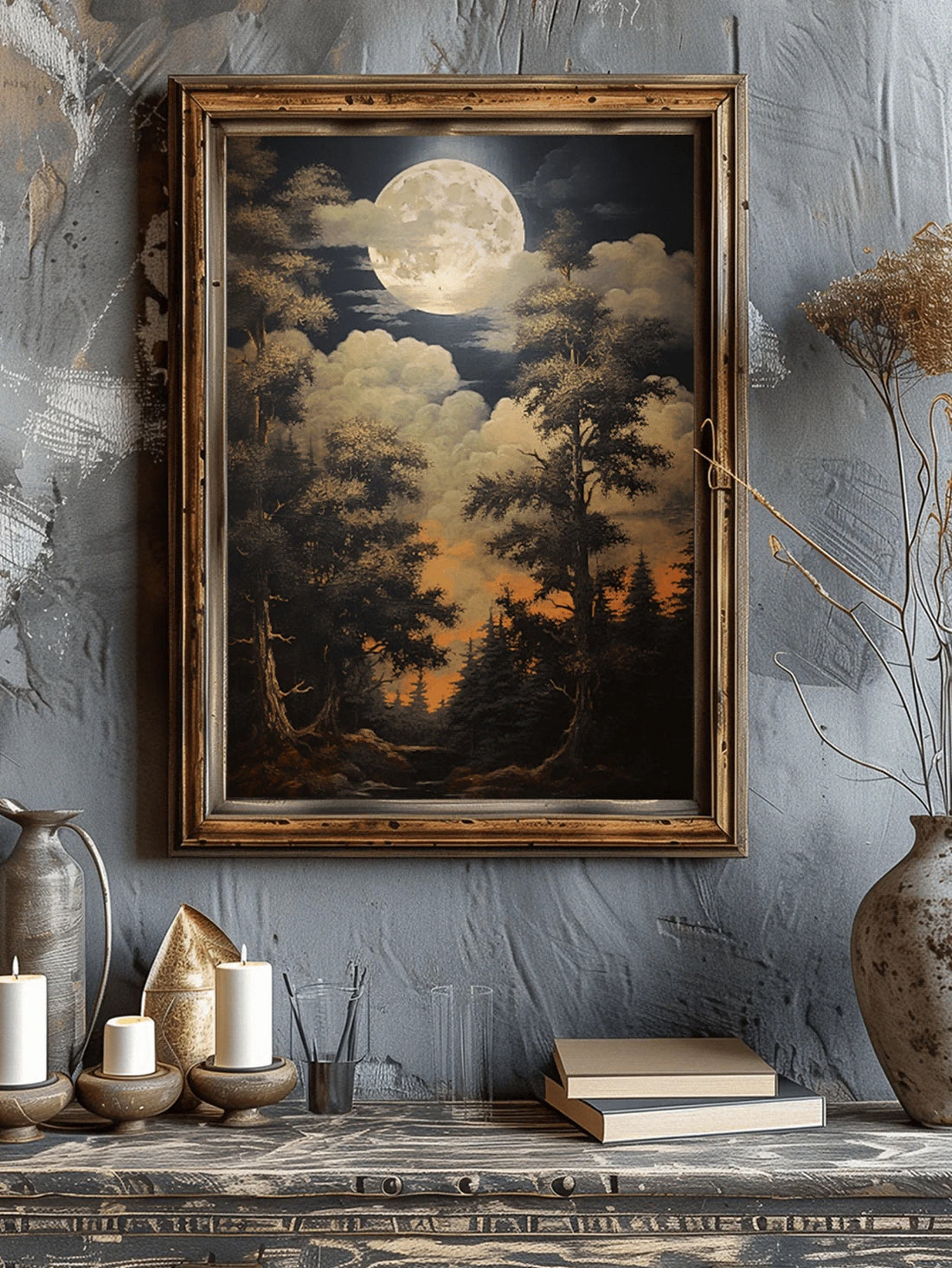 Framed vintage moonlit forest poster on blue wall above rustic console with candles books and vase