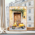Flat unframed yellow scooter and cascading flower artwork displayed on a bright windowsill