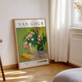 Framed Van Gogh floral poster leaning near bright window and radiator