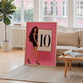Large pink coquette fashion doll poster with 10 score card leaning in bright living room