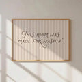 Framed laundry room quote print reading This room was made for washin on beige striped background