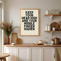 Honey wood frame display of funny attitude wall art in a bright kitchen vignette