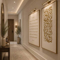 Two vertical gold Arabic calligraphy posters displayed along warm modern hallway