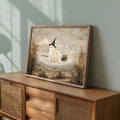 Flying sheet ghost landscape print leaning on rustic wood cabinet