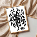 Wood framed black brush deity print lying on beige fabric close product styling