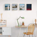 Surreal ghost poster gallery wall above gray sofa