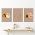 Three-piece autumn wall art set displayed above a floating shelf with woven decor