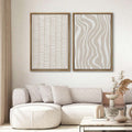 Neutral boho wall art set above beige sofa