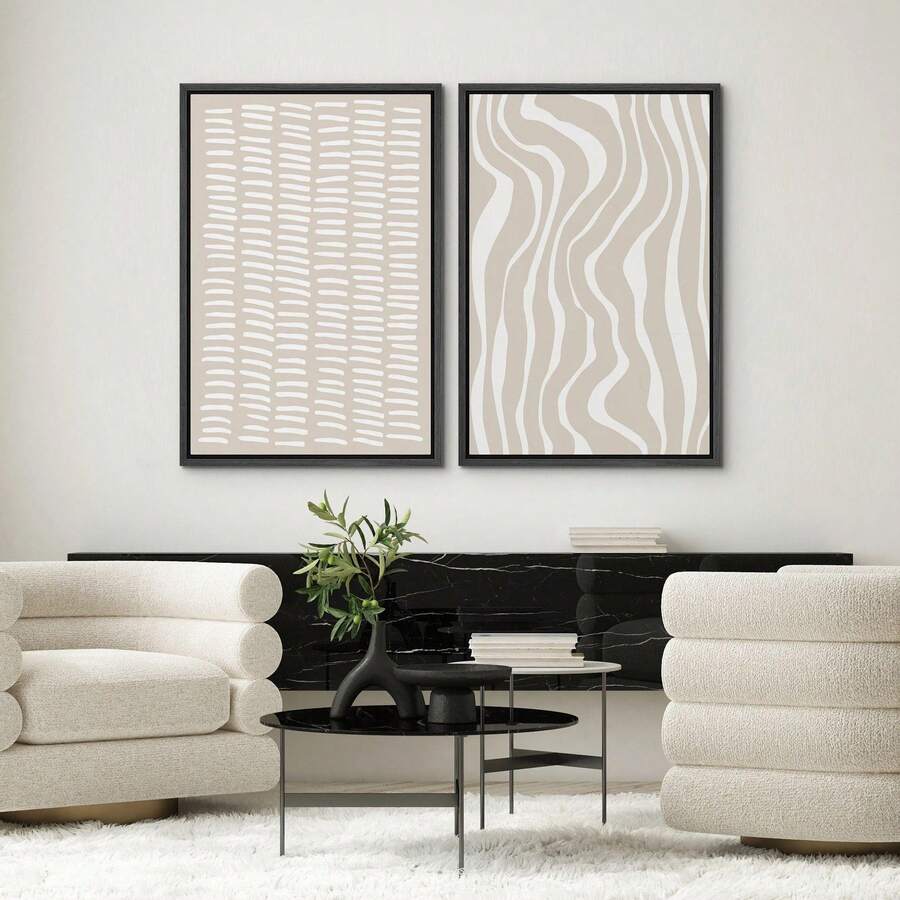 Geometric abstract canvas pair above cream chairs