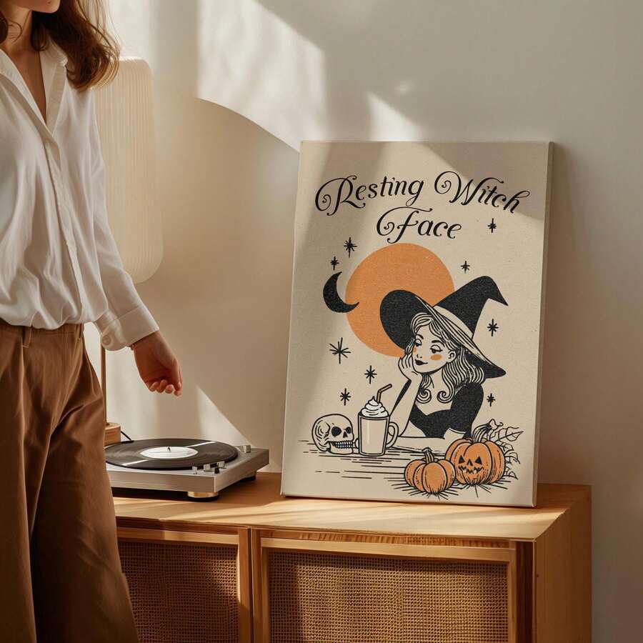 Unframed witch Halloween poster leaning on cabinet beside record player